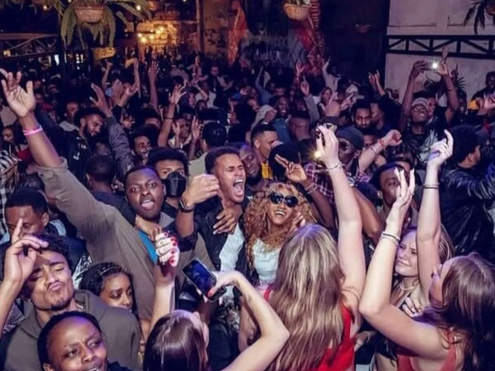 Packed crowd with hands in the air at a DJ Bogiside night