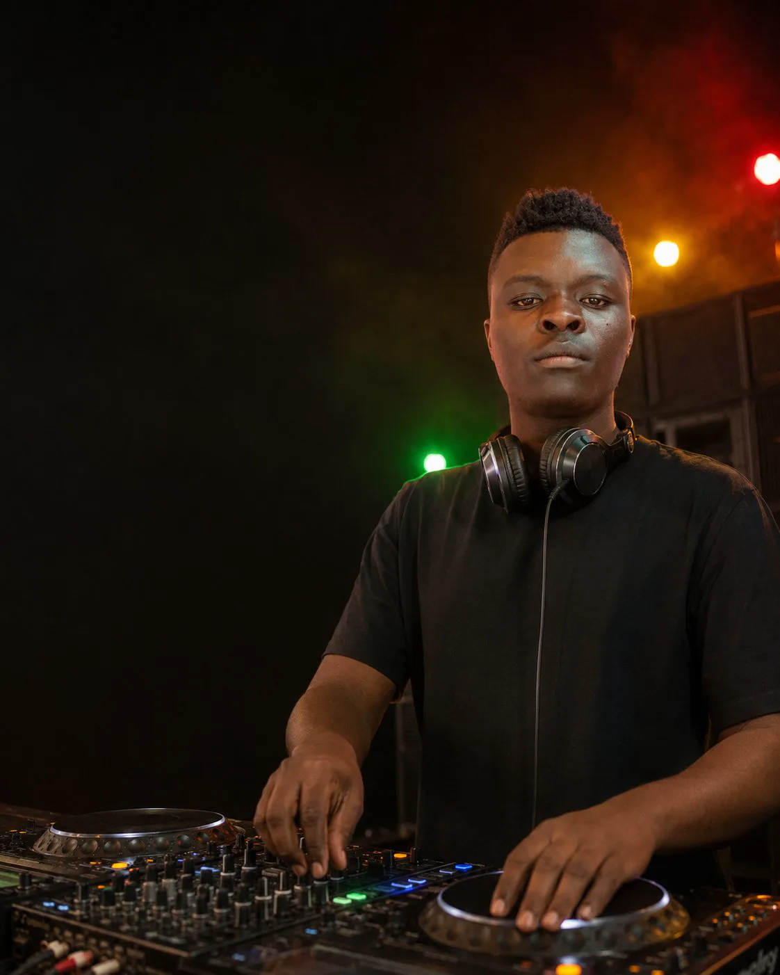 DJ Bogiside at the decks under green and red stage lights